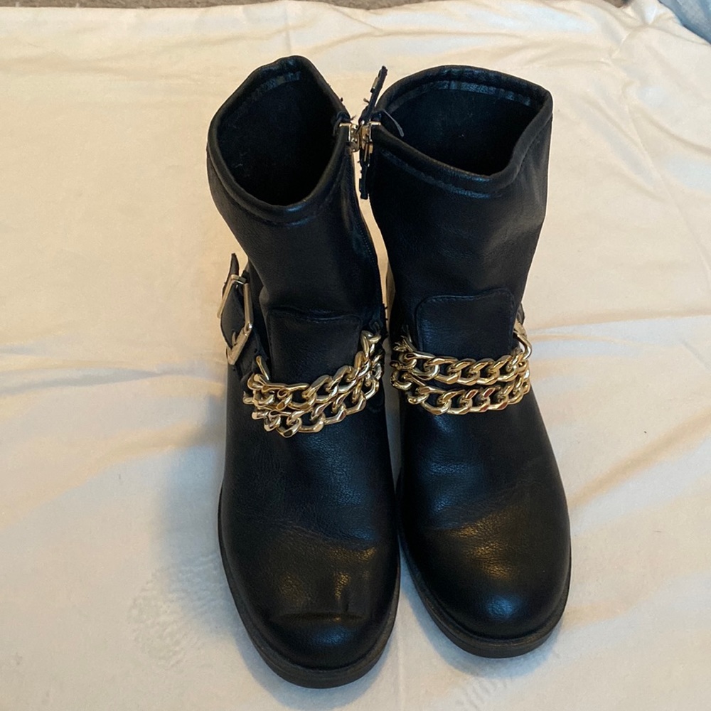 Black biker boots with gold chain accent.